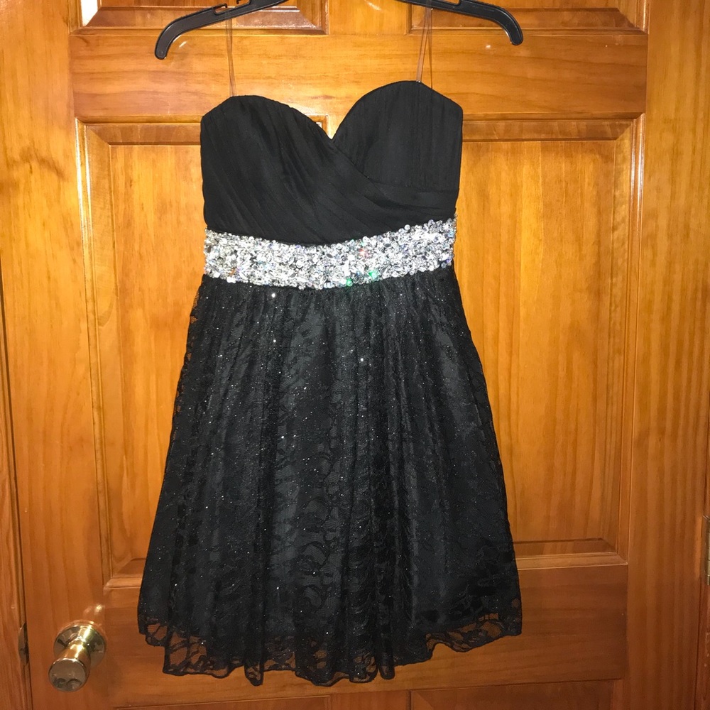 A strapless black glittery mini dress